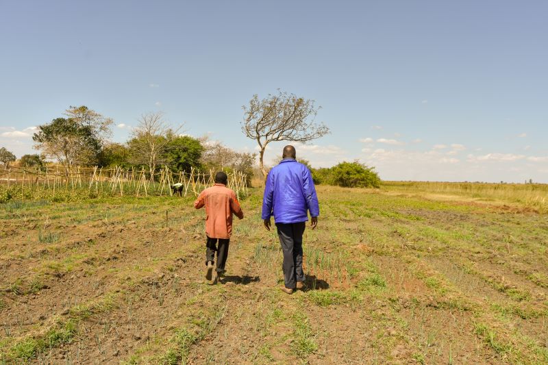 Morut Isyagi with a worker on Sani Ltd farm